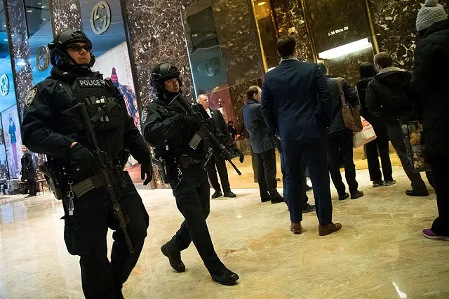 Heavily armed NYPD officers stroll through the lobby of Trump Tower, which is supposed to be open to the public in exchange for a zoning variance.
